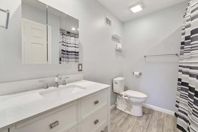 445 Belinda Pkwy, Mount Juliet, TN 37122 - bathroom featuring vanity, wood finished floors, toilet, baseboards, and a shower with shower curtain