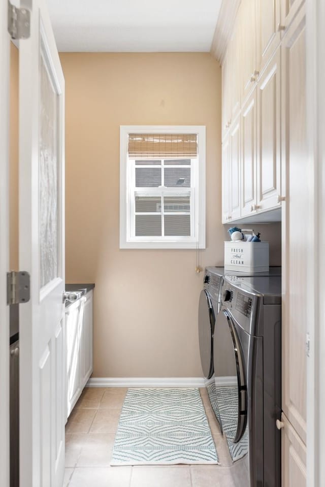 1300 Wentworth Dr, Gallatin, TN 37066 - washroom with cabinet space, washing machine and dryer, light tile patterned floors, and baseboards