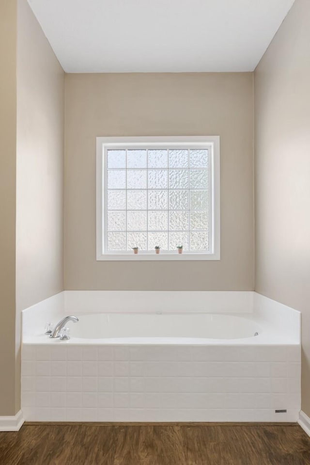 1300 Wentworth Dr, Gallatin, TN 37066 - full bath featuring healthy amount of natural light, wood finished floors, a garden tub, and baseboards