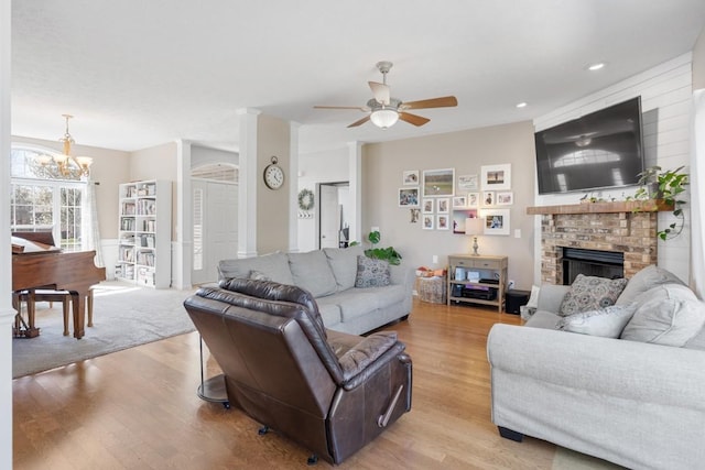 1300 Wentworth Dr, Gallatin, TN 37066 - living room featuring ceiling fan, light wood-type flooring, a fireplace, and a chandelier