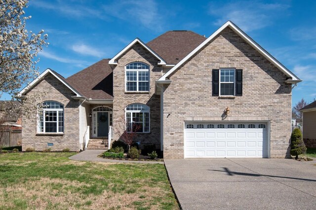 1300 Wentworth Dr, Gallatin, TN 37066 - traditional-style house featuring driveway, brick siding, a garage, and roof with shingles