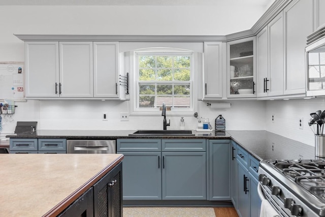 1300 Wentworth Dr, Gallatin, TN 37066 - kitchen with a sink, appliances with stainless steel finishes, tasteful backsplash, and glass insert cabinets