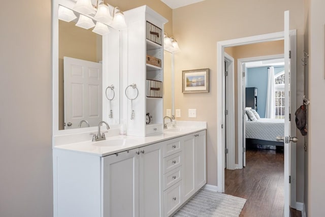 1300 Wentworth Dr, Gallatin, TN 37066 - full bathroom featuring double vanity, wood finished floors, ensuite bathroom, and baseboards