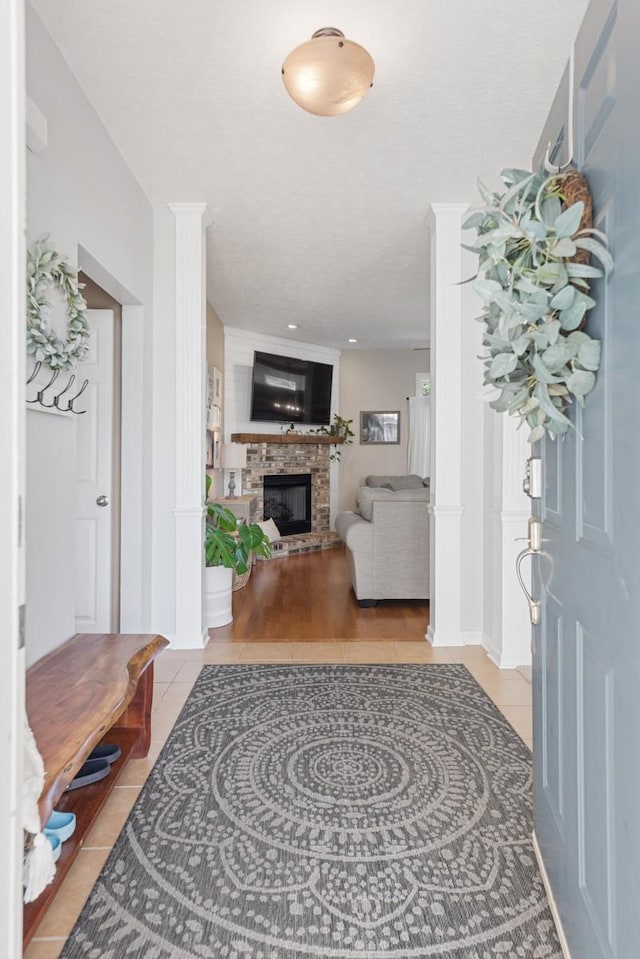 1300 Wentworth Dr, Gallatin, TN 37066 - foyer featuring a brick fireplace, tile patterned floors, and ornate columns