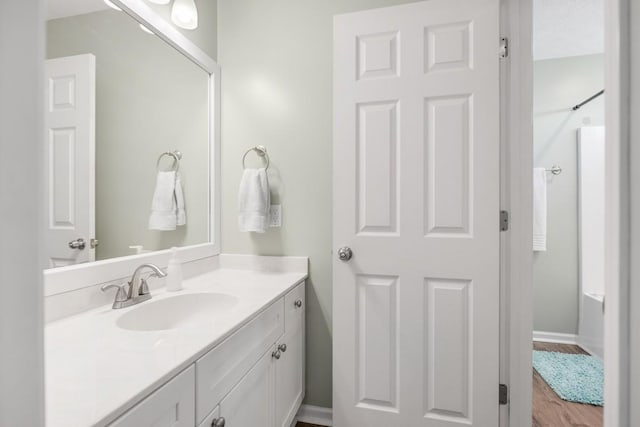 1300 Wentworth Dr, Gallatin, TN 37066 - bathroom featuring vanity, a shower, wood finished floors, and baseboards