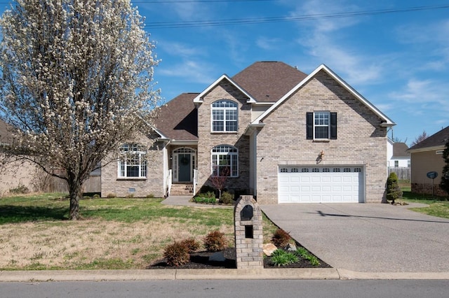 1300 Wentworth Dr, Gallatin, TN 37066 - traditional home with brick siding, a garage, driveway, and a front yard
