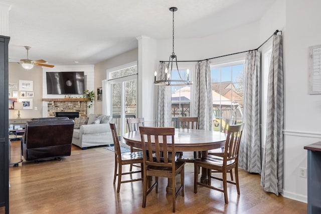 1300 Wentworth Dr, Gallatin, TN 37066 - dining space with a fireplace, a ceiling fan, healthy amount of natural light, and wood finished floors