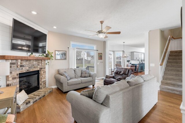 1300 Wentworth Dr, Gallatin, TN 37066 - living room with stairs, ceiling fan, wood finished floors, a fireplace, and baseboards