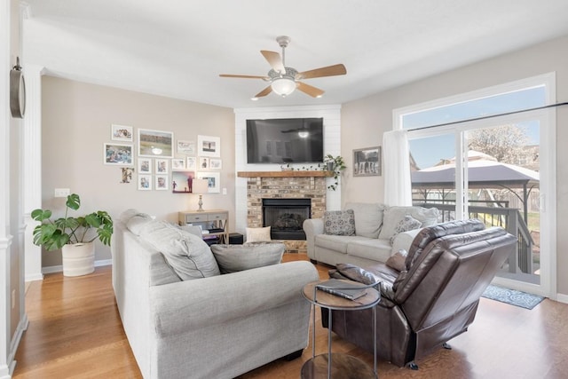 1300 Wentworth Dr, Gallatin, TN 37066 - living area featuring light wood-type flooring, ceiling fan, a brick fireplace, and baseboards