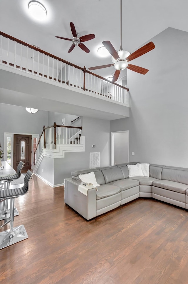 1838 Oreilly Cir, Spring Hill, TN 37174 - living area featuring a high ceiling, ceiling fan, stairs, wood finished floors, and baseboards