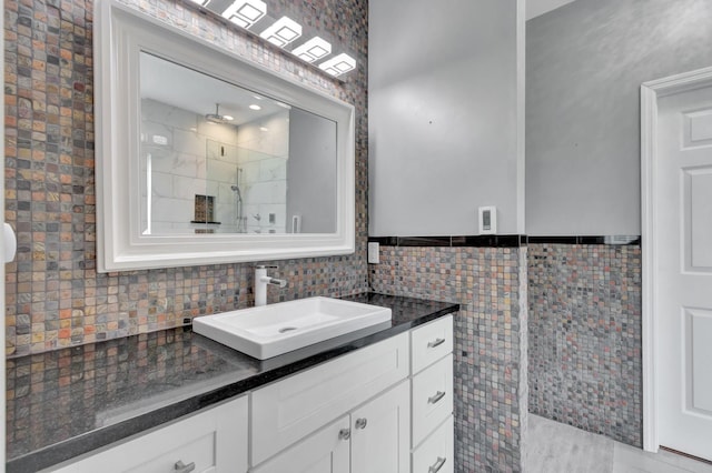 1838 Oreilly Cir, Spring Hill, TN 37174 - bathroom featuring vanity, a tile shower, wainscoting, and tile walls