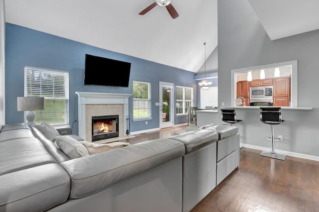1838 Oreilly Cir, Spring Hill, TN 37174 - living area with ceiling fan, high vaulted ceiling, dark wood-style flooring, a tile fireplace, and baseboards