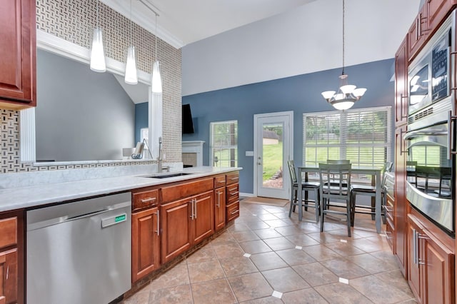 1838 Oreilly Cir, Spring Hill, TN 37174 - kitchen featuring appliances with stainless steel finishes, tasteful backsplash, a chandelier, a sink, and light countertops