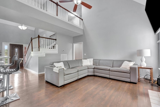 1838 Oreilly Cir, Spring Hill, TN 37174 - living area featuring a towering ceiling, a ceiling fan, wood finished floors, stairs, and baseboards