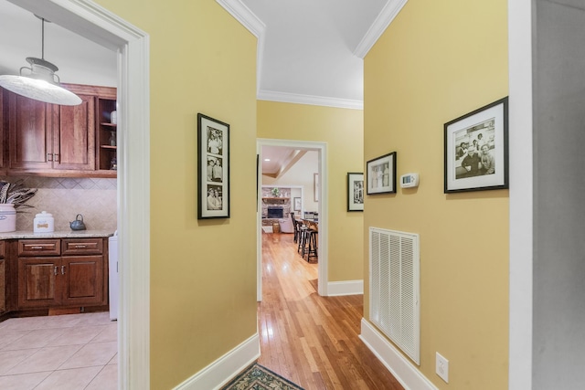15687 Columbia Hwy, Lynnville, TN 38472 - corridor featuring crown molding, light wood-style floors, and baseboards