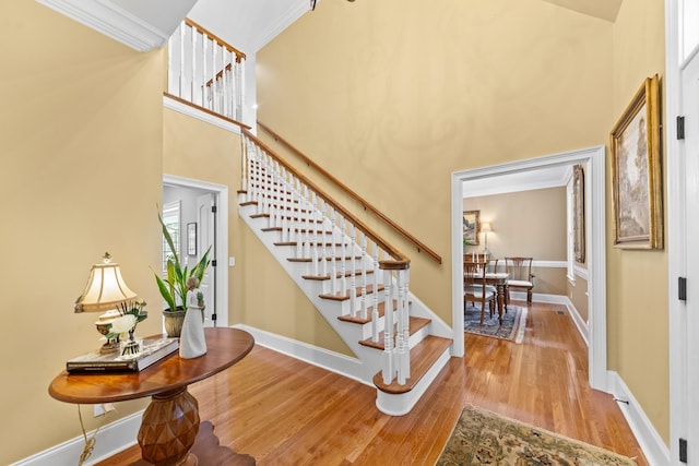15687 Columbia Hwy, Lynnville, TN 38472 - stairs with wood finished floors, crown molding, baseboards, and a high ceiling