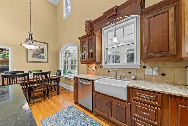 15687 Columbia Hwy, Lynnville, TN 38472 - kitchen featuring dishwasher, a sink, a high ceiling, hanging light fixtures, and light wood-type flooring