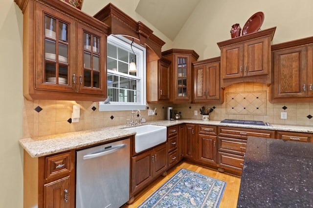 15687 Columbia Hwy, Lynnville, TN 38472 - kitchen featuring stainless steel appliances, a sink, vaulted ceiling, light wood-style flooring, and light stone counters