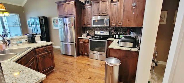 222 Pumphill Rd, Dickson, TN 37055 - kitchen featuring appliances with stainless steel finishes, a sink, tasteful backsplash, light wood finished floors, and baseboards