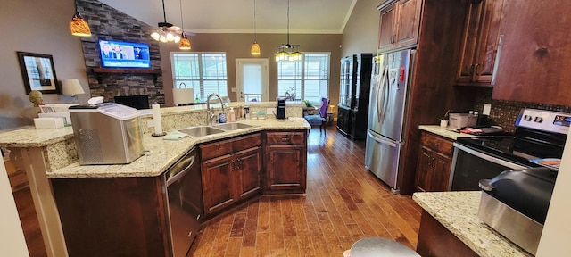 222 Pumphill Rd, Dickson, TN 37055 - kitchen featuring a sink, stainless steel appliances, dark wood-style flooring, a stone fireplace, and open floor plan