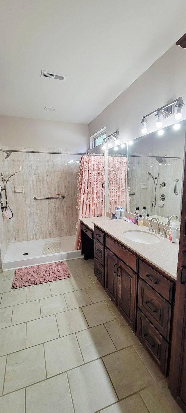 222 Pumphill Rd, Dickson, TN 37055 - bathroom featuring tiled shower, vanity, and tile patterned floors