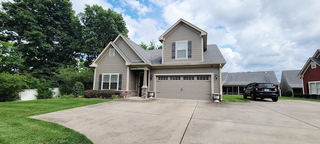 222 Pumphill Rd, Dickson, TN 37055 - view of front of property featuring driveway, a front lawn, stone siding, and a garage