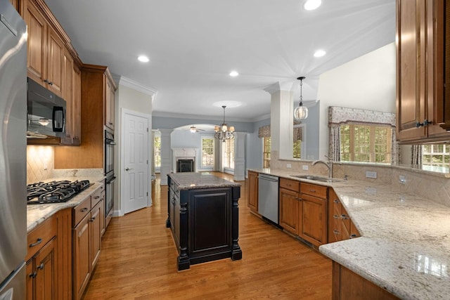 3037 Flagstone Dr, Franklin, TN 37069 - kitchen featuring black appliances, a sink, light stone countertops, tasteful backsplash, and crown molding