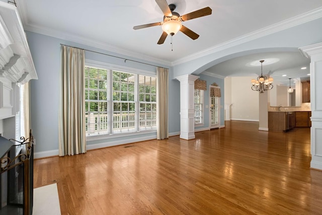 3037 Flagstone Dr, Franklin, TN 37069 - unfurnished living room with ceiling fan, a chandelier, decorative columns, wood finished floors, and baseboards