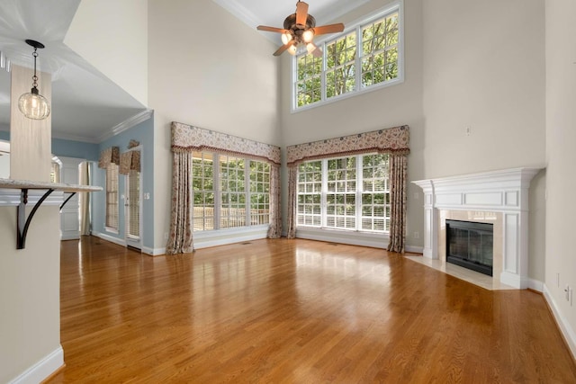 3037 Flagstone Dr, Franklin, TN 37069 - unfurnished living room featuring ornamental molding, wood finished floors, a ceiling fan, a premium fireplace, and baseboards