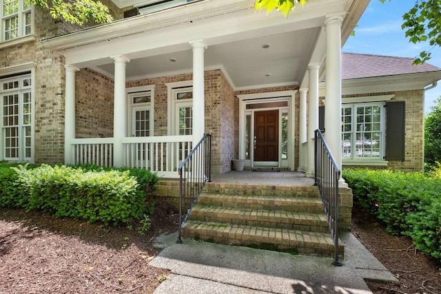 3037 Flagstone Dr, Franklin, TN 37069 - doorway to property with brick siding, roof with shingles, and a porch
