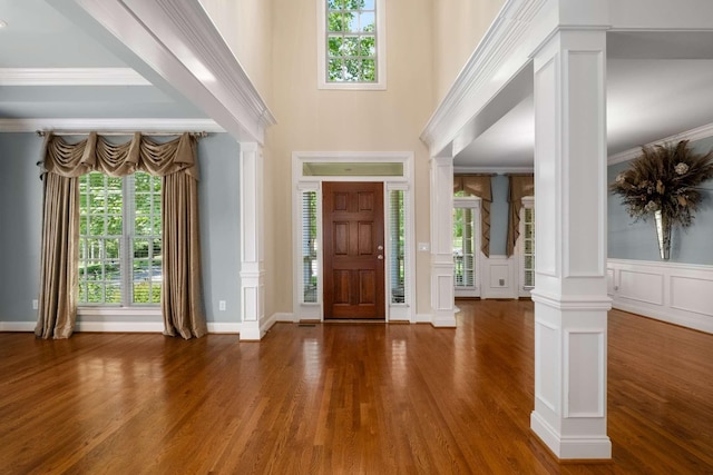 3037 Flagstone Dr, Franklin, TN 37069 - entryway with decorative columns, wood finished floors, a decorative wall, wainscoting, and a towering ceiling