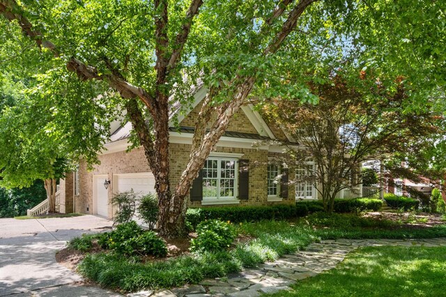 3037 Flagstone Dr, Franklin, TN 37069 - view of front of home featuring brick siding, concrete driveway, and a garage