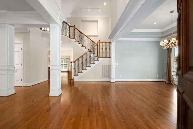 3037 Flagstone Dr, Franklin, TN 37069 - entrance foyer featuring stairs, wood finished floors, crown molding, ornate columns, and baseboards