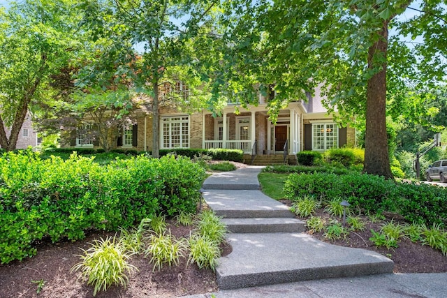 3037 Flagstone Dr, Franklin, TN 37069 - view of property hidden behind natural elements featuring covered porch and brick siding