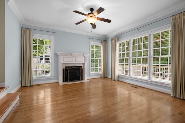3037 Flagstone Dr, Franklin, TN 37069 - unfurnished living room with baseboards, ornamental molding, a premium fireplace, wood finished floors, and healthy amount of natural light