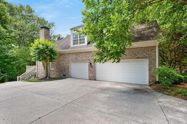 3037 Flagstone Dr, Franklin, TN 37069 - view of front of home with concrete driveway, a chimney, brick siding, and a shingled roof