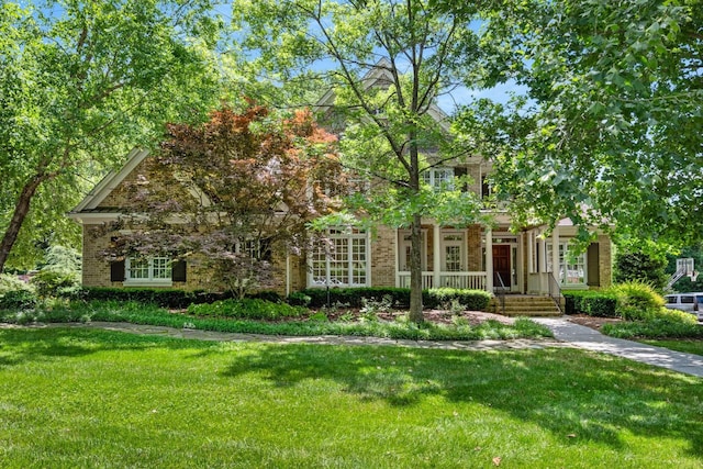 3037 Flagstone Dr, Franklin, TN 37069 - obstructed view of property with a porch, a front yard, and brick siding