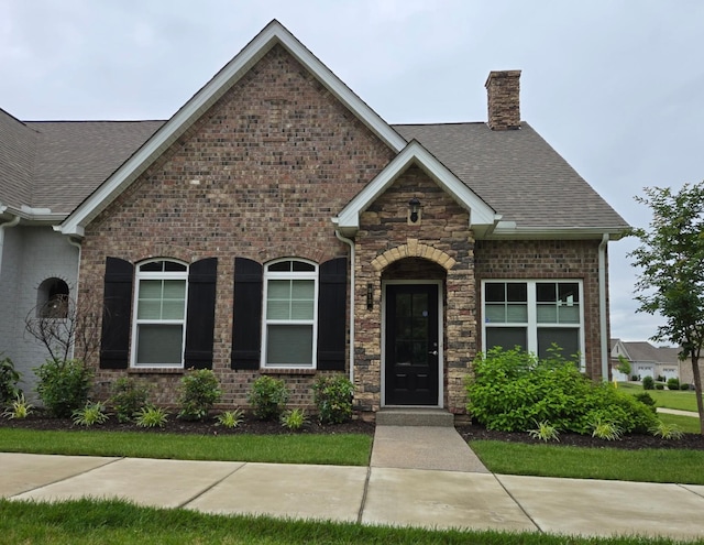 312 Buckner Cir, Mount Juliet, TN 37122 - view of front of home with roof with shingles, a chimney, brick siding, and stone siding