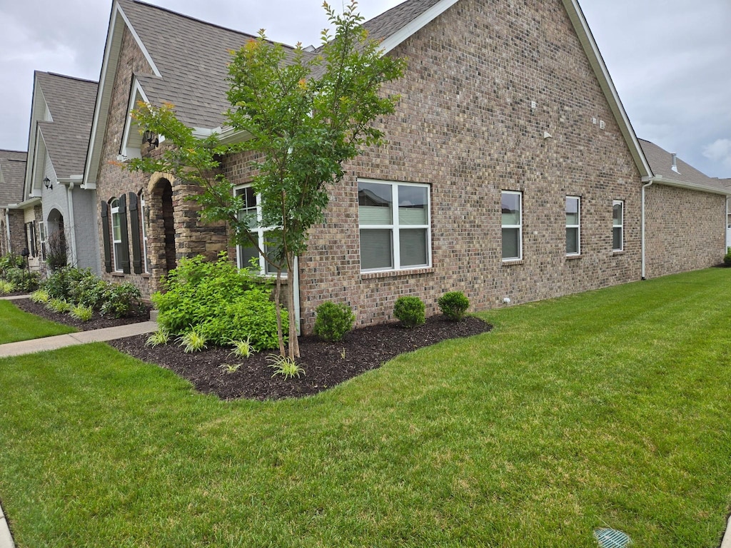 312 Buckner Cir, Mount Juliet, TN 37122 - view of side of home featuring brick siding, a lawn, and roof with shingles