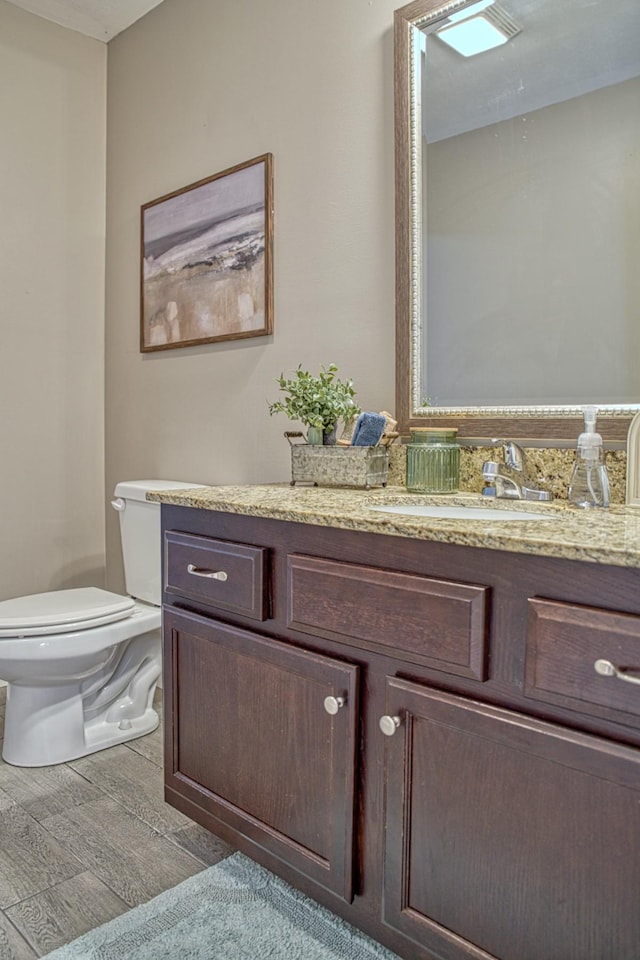 143 Rachelle Pl, Baxter, TN 38544 - bathroom with toilet, vanity, and wood finished floors