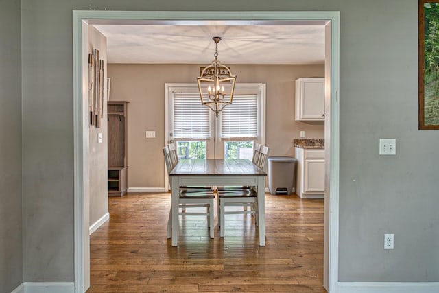 143 Rachelle Pl, Baxter, TN 38544 - dining area featuring a chandelier, wood finished floors, and baseboards