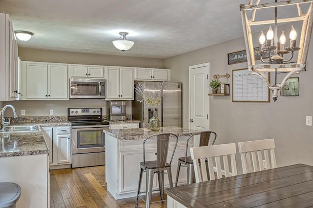 143 Rachelle Pl, Baxter, TN 38544 - kitchen featuring stainless steel appliances, a sink, stone countertops, and white cabinetry