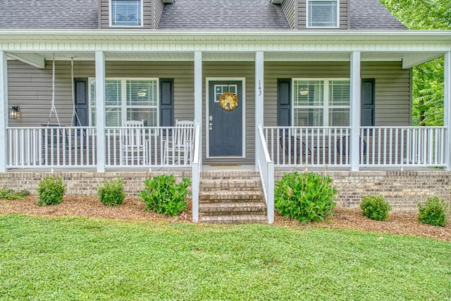 143 Rachelle Pl, Baxter, TN 38544 - doorway to property featuring a shingled roof, a lawn, and a porch
