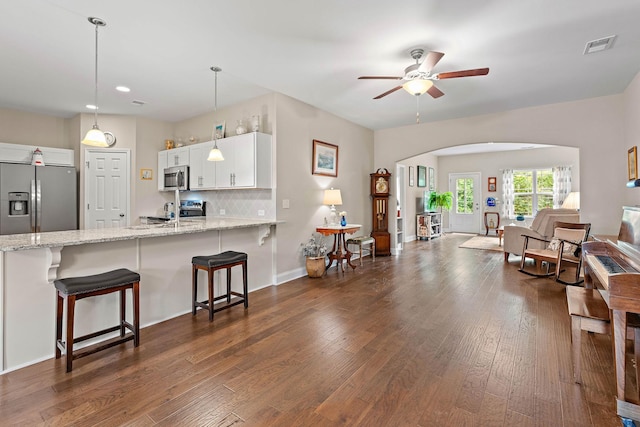 1648 Foston Ln, Gallatin, TN 37066 - kitchen featuring stainless steel appliances, a peninsula, ceiling fan, arched walkways, and white cabinets