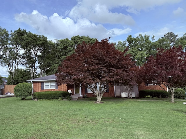 435 Richland Cir, Gallatin, TN 37066 - view of property hidden behind natural elements featuring a front yard, brick siding, and a garage