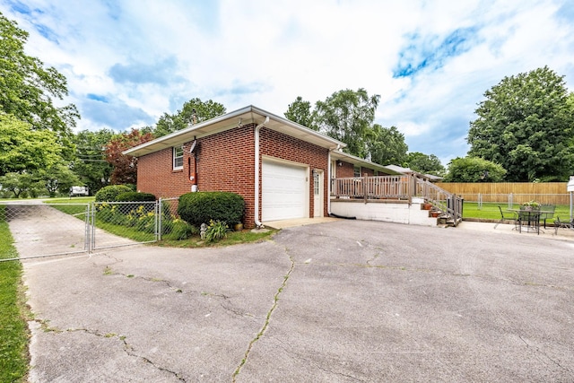 435 Richland Cir, Gallatin, TN 37066 - view of side of home featuring brick siding, an attached garage, driveway, and a gate