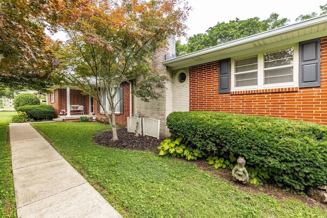 435 Richland Cir, Gallatin, TN 37066 - view of front of home featuring brick siding, a front yard, and a chimney