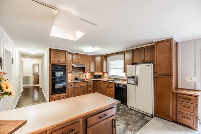 435 Richland Cir, Gallatin, TN 37066 - kitchen with black appliances, brown cabinets, under cabinet range hood, and decorative backsplash