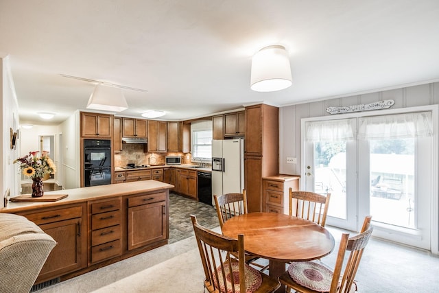 435 Richland Cir, Gallatin, TN 37066 - kitchen featuring black appliances, light colored carpet, and brown cabinetry