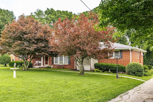 435 Richland Cir, Gallatin, TN 37066 - view of property hidden behind natural elements featuring a front lawn and brick siding